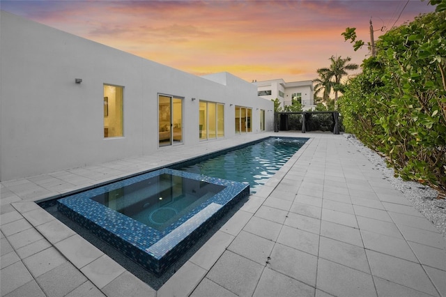3500 Bay Shore Rd, Sarasota, FL 34234 - pool at dusk with a patio area and a pool with connected hot tub