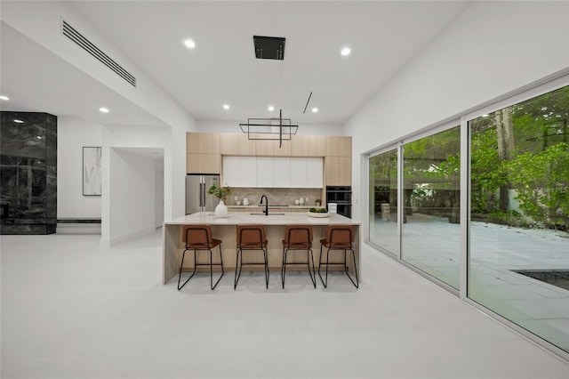 3500 Bay Shore Rd, Sarasota, FL 34234 - kitchen with freestanding refrigerator, modern cabinets, decorative backsplash, recessed lighting, and light countertops