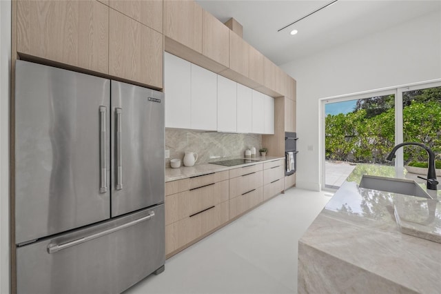 3500 Bay Shore Rd, Sarasota, FL 34234 - kitchen featuring high end fridge, modern cabinets, light brown cabinetry, decorative backsplash, and recessed lighting