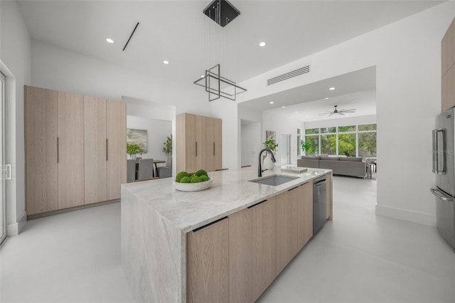 3500 Bay Shore Rd, Sarasota, FL 34234 - kitchen featuring modern cabinets, appliances with stainless steel finishes, light brown cabinetry, light stone counters, and finished concrete floors