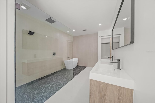 3500 Bay Shore Rd, Sarasota, FL 34234 - bathroom featuring a freestanding tub, double vanity, recessed lighting, and a walk in shower
