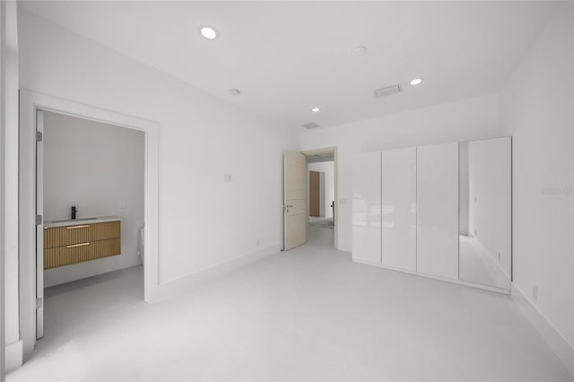 3500 Bay Shore Rd, Sarasota, FL 34234 - unfurnished bedroom with recessed lighting, a closet, and concrete floors