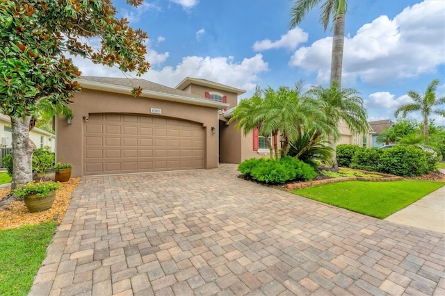 6305 Golden Eye Gln, Lakewood Ranch, FL 34202 - view of front facade with an attached garage, stucco siding, and decorative driveway