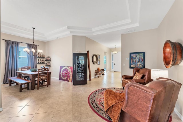 6305 Golden Eye Gln, Lakewood Ranch, FL 34202 - living area featuring a raised ceiling, a chandelier, light tile patterned floors, and crown molding
