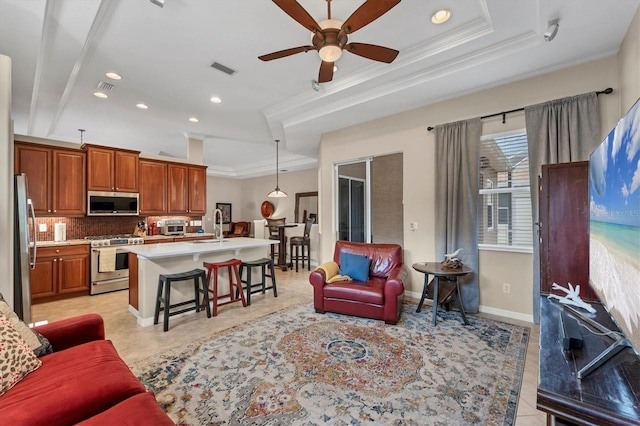 6305 Golden Eye Gln, Lakewood Ranch, FL 34202 - living room featuring ornamental molding, recessed lighting, ceiling fan, a tray ceiling, and light tile patterned floors
