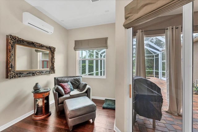 6305 Golden Eye Gln, Lakewood Ranch, FL 34202 - living area featuring an AC wall unit and wood finished floors