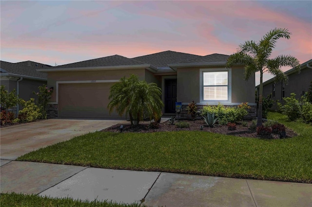 12357 Nantahala Run, Parrish, FL 34219 - view of front facade with stucco siding, an attached garage, and a front yard