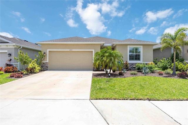 12357 Nantahala Run, Parrish, FL 34219 - view of front facade with stucco siding, an attached garage, concrete driveway, a front yard, and stone siding