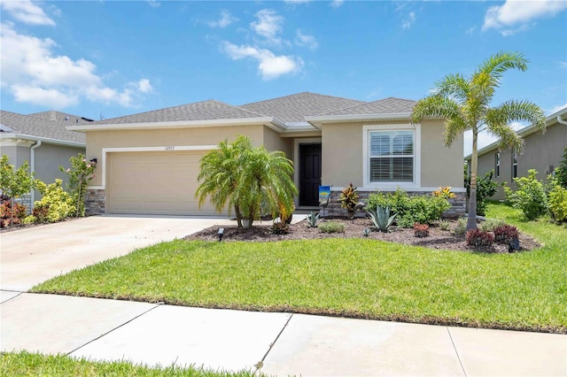 12357 Nantahala Run, Parrish, FL 34219 - view of front of home with stucco siding, an attached garage, a front lawn, and concrete driveway