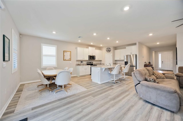 12357 Nantahala Run, Parrish, FL 34219 - dining space featuring light wood finished floors and recessed lighting