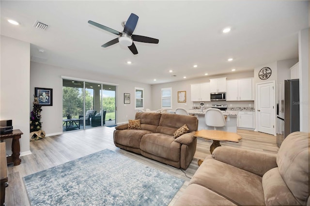 12357 Nantahala Run, Parrish, FL 34219 - living area with light wood finished floors, recessed lighting, and a ceiling fan
