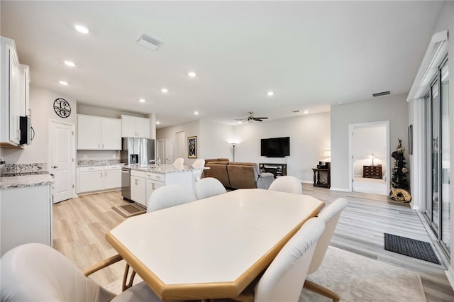 12357 Nantahala Run, Parrish, FL 34219 - dining room with light wood finished floors, recessed lighting, and ceiling fan