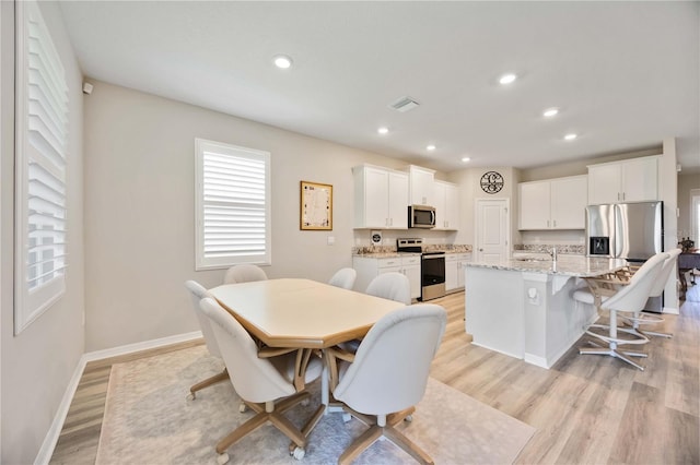 12357 Nantahala Run, Parrish, FL 34219 - dining space with recessed lighting and light wood finished floors