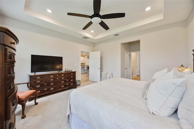 12357 Nantahala Run, Parrish, FL 34219 - bedroom with a tray ceiling, recessed lighting, a ceiling fan, and light carpet