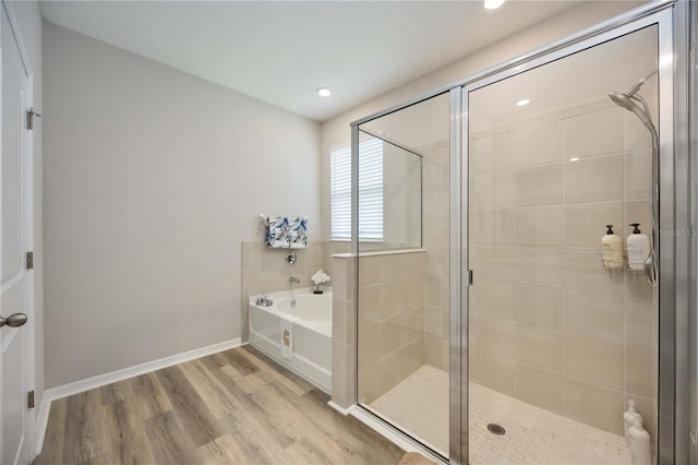 12357 Nantahala Run, Parrish, FL 34219 - bathroom featuring a garden tub, a shower stall, wood finished floors, and recessed lighting