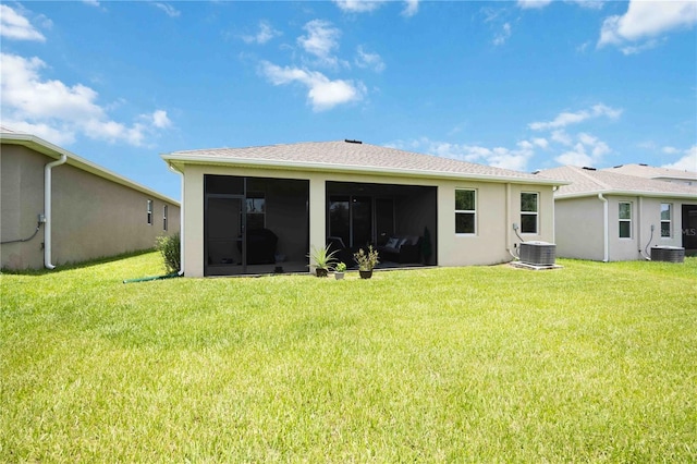12357 Nantahala Run, Parrish, FL 34219 - back of property with a sunroom, a yard, and stucco siding