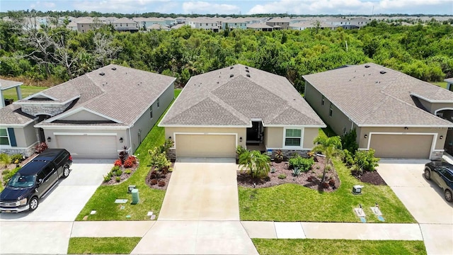 12357 Nantahala Run, Parrish, FL 34219 - view of front facade with stucco siding, concrete driveway, a front lawn, and a garage