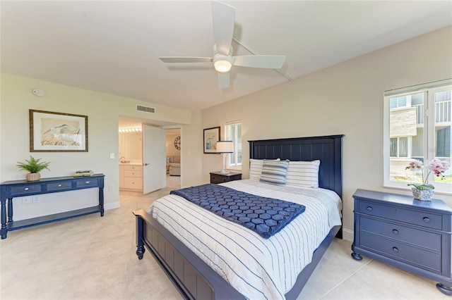 4805 Gulf Of Mexico Dr Unit 105, Longboat Key, FL 34228 - bedroom featuring light tile patterned floors, ensuite bath, and a ceiling fan