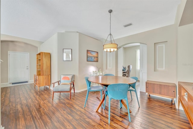 14255 Gnatcatcher Ter, Lakewood Ranch, FL 34202 - dining space with arched walkways, wood finished floors, and a chandelier