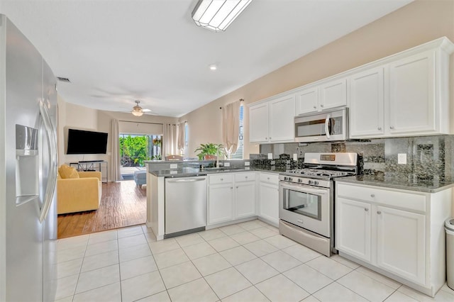 14255 Gnatcatcher Ter, Lakewood Ranch, FL 34202 - kitchen featuring stainless steel appliances, open floor plan, a peninsula, and white cabinetry