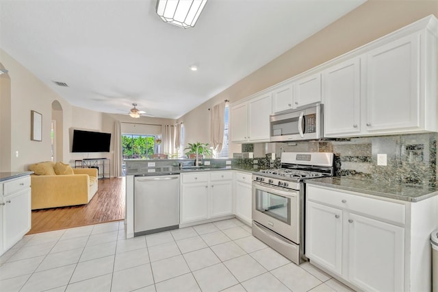 14255 Gnatcatcher Ter, Lakewood Ranch, FL 34202 - kitchen with stainless steel appliances, ceiling fan, open floor plan, a peninsula, and white cabinetry