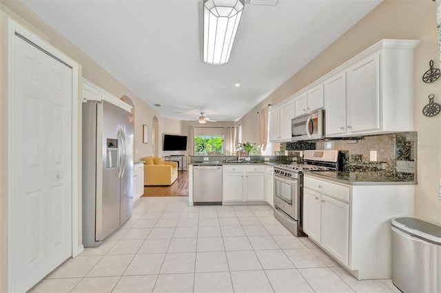 14255 Gnatcatcher Ter, Lakewood Ranch, FL 34202 - kitchen with appliances with stainless steel finishes, open floor plan, white cabinets, a peninsula, and dark countertops