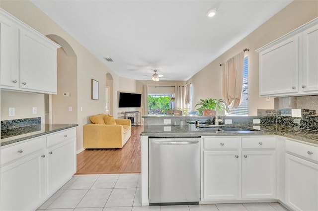 14255 Gnatcatcher Ter, Lakewood Ranch, FL 34202 - kitchen featuring stainless steel dishwasher, a ceiling fan, a peninsula, white cabinetry, and arched walkways