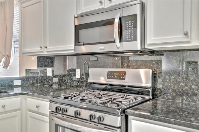 14255 Gnatcatcher Ter, Lakewood Ranch, FL 34202 - kitchen featuring stainless steel appliances, white cabinetry, and decorative backsplash
