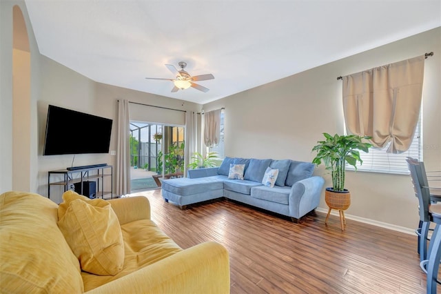 14255 Gnatcatcher Ter, Lakewood Ranch, FL 34202 - living room featuring a ceiling fan, wood finished floors, and arched walkways