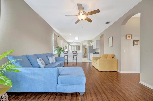14255 Gnatcatcher Ter, Lakewood Ranch, FL 34202 - living room featuring arched walkways, a ceiling fan, and wood finished floors