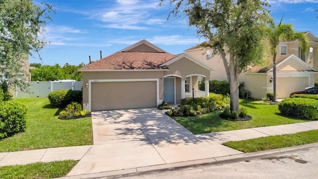 14255 Gnatcatcher Ter, Lakewood Ranch, FL 34202 - view of front facade featuring a garage, driveway, and stucco siding