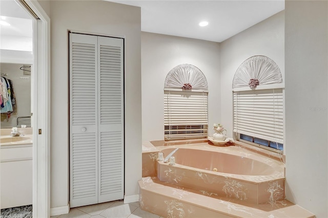 80 Rio Cuarto St, Punta Gorda, FL 33983 - bathroom with a closet, vanity, a whirlpool tub, tile patterned flooring, and recessed lighting