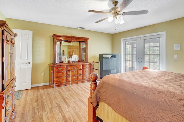 80 Rio Cuarto St, Punta Gorda, FL 33983 - bedroom with french doors, light wood-style floors, access to exterior, a ceiling fan, and a textured ceiling