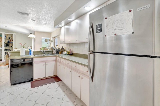 80 Rio Cuarto St, Punta Gorda, FL 33983 - kitchen with freestanding refrigerator, dishwasher, a textured ceiling, a peninsula, and light countertops