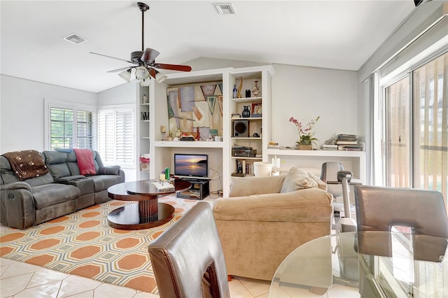 80 Rio Cuarto St, Punta Gorda, FL 33983 - living area with vaulted ceiling, tile patterned floors, ceiling fan, and built in features