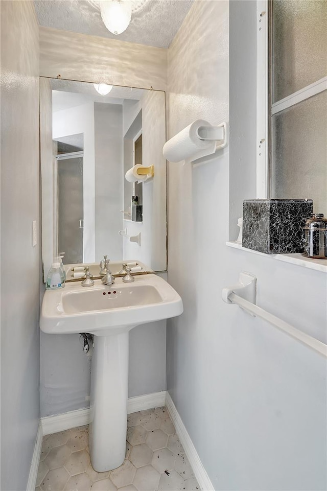 80 Rio Cuarto St, Punta Gorda, FL 33983 - bathroom featuring a textured ceiling and tile patterned floors