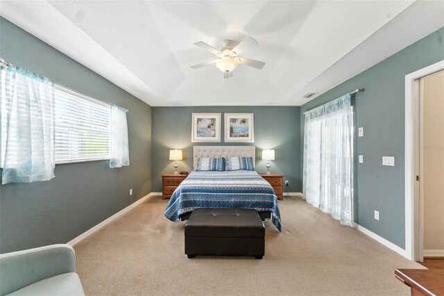 194 Sunset Rd, Rotonda West, FL 33947 - carpeted bedroom with a raised ceiling, multiple windows, and ceiling fan