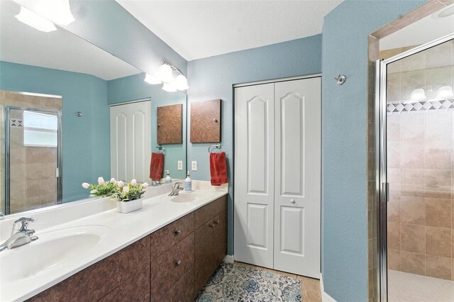 194 Sunset Rd, Rotonda West, FL 33947 - bathroom featuring a shower stall, a closet, and double vanity