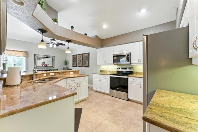 194 Sunset Rd, Rotonda West, FL 33947 - kitchen with appliances with stainless steel finishes, white cabinets, decorative light fixtures, ceiling fan, and recessed lighting