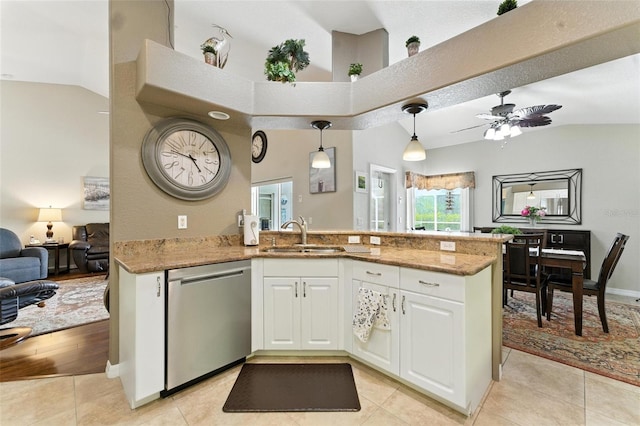 194 Sunset Rd, Rotonda West, FL 33947 - kitchen featuring stainless steel dishwasher, white cabinets, open floor plan, light tile patterned flooring, and a peninsula