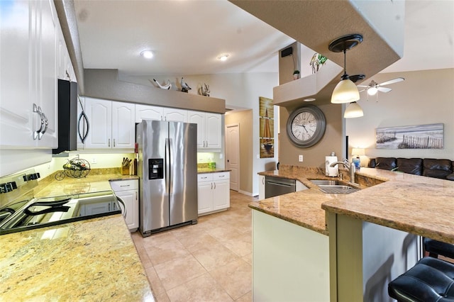 194 Sunset Rd, Rotonda West, FL 33947 - kitchen with appliances with stainless steel finishes, a peninsula, white cabinetry, ceiling fan, and lofted ceiling