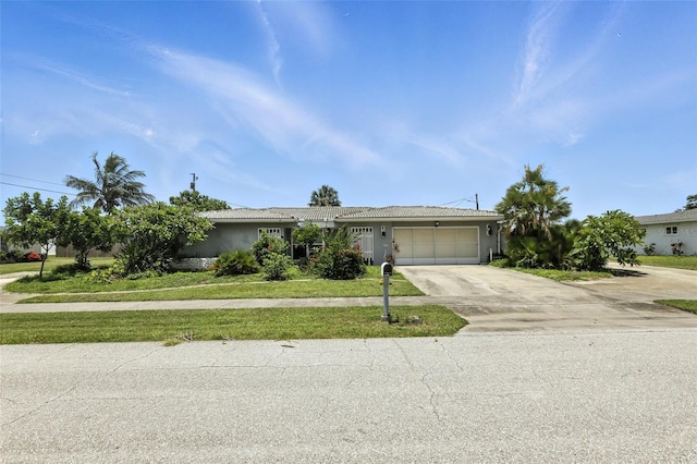 326 Mann Ave SE, Port Charlotte, FL 33952 - ranch-style home with a garage, concrete driveway, stucco siding, and a front lawn