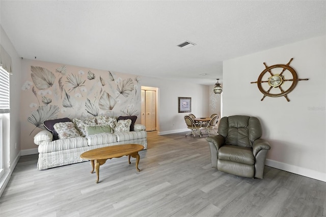 326 Mann Ave SE, Port Charlotte, FL 33952 - living area featuring baseboards and wood finished floors