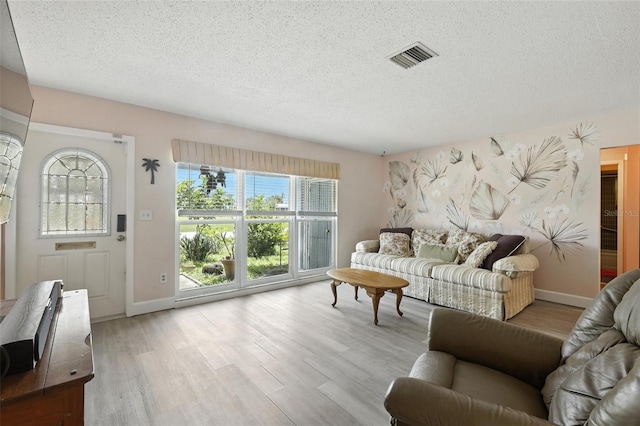 326 Mann Ave SE, Port Charlotte, FL 33952 - living area with a textured ceiling and wood finished floors
