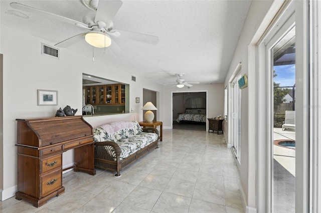 326 Mann Ave SE, Port Charlotte, FL 33952 - bedroom with access to outside, a textured ceiling, light tile patterned floors, and ceiling fan