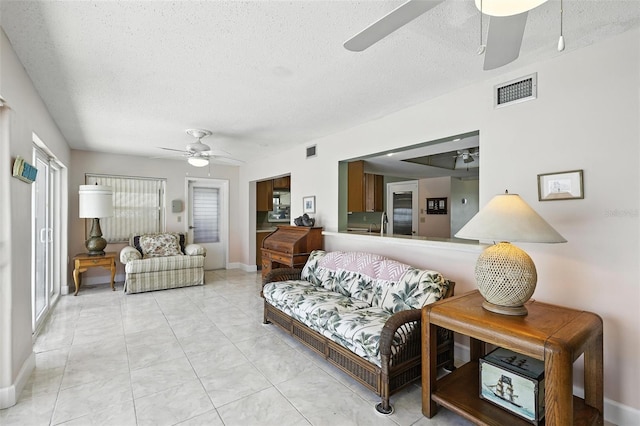 326 Mann Ave SE, Port Charlotte, FL 33952 - living room with a ceiling fan and a textured ceiling