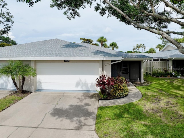 4339 Bowling Green Cir Unit 19, Sarasota, FL 34233 - ranch-style house featuring an attached garage, concrete driveway, a front yard, roof with shingles, and stucco siding