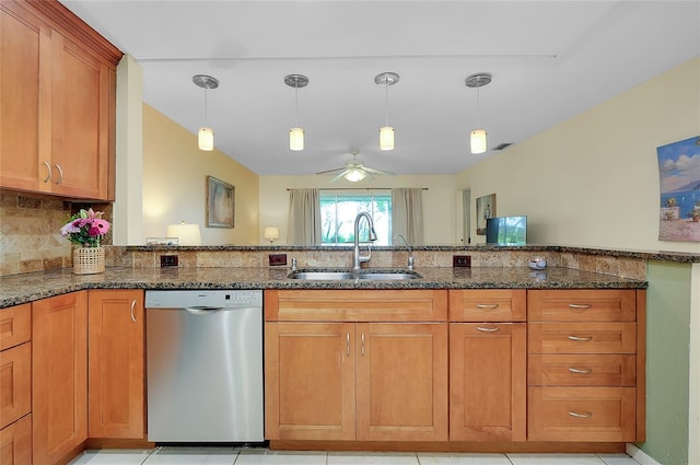 4339 Bowling Green Cir Unit 19, Sarasota, FL 34233 - kitchen featuring stainless steel dishwasher, dark stone countertops, brown cabinetry, and decorative light fixtures