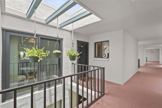 3705 E Bay Dr Unit 205, Holmes Beach, FL 34217 - hallway featuring a skylight and an upstairs landing
