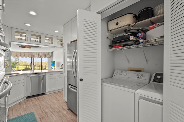3705 E Bay Dr Unit 205, Holmes Beach, FL 34217 - laundry area featuring washer and clothes dryer, recessed lighting, and light wood finished floors